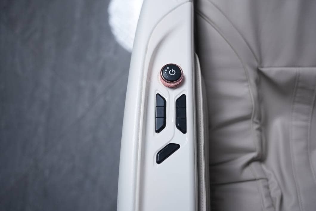 Rose-gold power dial and recline buttons on the armrest