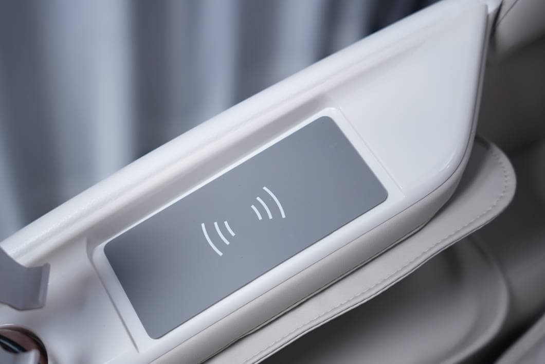 Wireless charging pad built into the armrest